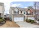Inviting two-story home featuring a two-car garage and well-maintained landscaping at 1212 Lake Point Way, Suwanee, GA 30024