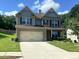 Beautiful two-story home with a two-car garage, and landscaped front yard and the perfect amount of greenery at 239 Lenore Ct, Hiram, GA 30141