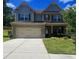 Charming two-story home with a well-manicured lawn and a two-car garage, creating a welcoming curb appeal at 239 Lenore Ct, Hiram, GA 30141