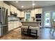 Modern kitchen with stainless steel appliances, granite countertops, and a kitchen island with barstool seating at 239 Lenore Ct, Hiram, GA 30141