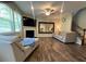 Spacious living room with a cozy fireplace, large mirror, and hardwood floors, creating an inviting atmosphere at 239 Lenore Ct, Hiram, GA 30141