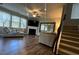 Inviting living room with hardwood floors, fireplace, and large windows, providing ample natural light at 239 Lenore Ct, Hiram, GA 30141