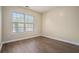 Bright, empty bedroom with hardwood floors and a large window offering plenty of natural light at 734 Celeste Sw Ln # 84, Atlanta, GA 30331