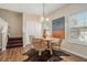 Cozy dining area featuring wood floors, modern lighting, and a unique decorative rug at 734 Celeste Sw Ln # 84, Atlanta, GA 30331