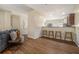 Open-concept living room with hardwood floors, neutral walls and bar-style seating at the kitchen counter at 734 Celeste Sw Ln # 84, Atlanta, GA 30331