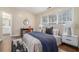 Bright bedroom featuring a neutral color palette, large windows, and a connected bathroom at 734 Celeste Sw Ln # 84, Atlanta, GA 30331