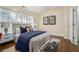 Comfortable bedroom with a large window, neutral decor, and hardwood floors at 734 Celeste Sw Ln # 84, Atlanta, GA 30331