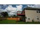 Exterior shot of the house and deck, showcasing the expansive backyard and side of the house with windows at 11854 Registry Blvd, Hampton, GA 30228