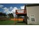 Outside view of the deck, overlooking the backyard with a wooden fence, and the side of the home with visible windows at 11854 Registry Blvd, Hampton, GA 30228