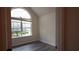 Bedroom with tall arched window and light gray flooring at 11854 Registry Blvd, Hampton, GA 30228