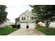 Charming two-story home featuring a two-car garage and well-maintained front yard at 11854 Registry Blvd, Hampton, GA 30228