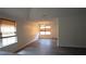 Bright living room featuring hardwood floors, two large windows, and an adjacent dining area at 11854 Registry Blvd, Hampton, GA 30228