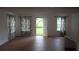 Open-concept living room with laminate floors and a door to the backyard at 11854 Registry Blvd, Hampton, GA 30228