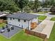 Aerial view of the home, backyard, firepit, and driveway at 1048 Pinehurst Se Dr, Smyrna, GA 30080