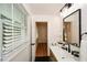 Modern bathroom featuring stylish vanity and black accents with views to exterior at 1048 Pinehurst Se Dr, Smyrna, GA 30080
