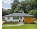 Charming single-story home featuring a blend of white painted brick and wood siding, with a well-manicured lawn at 1048 Pinehurst Se Dr, Smyrna, GA 30080