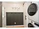 Bright laundry room featuring a stacked washer and dryer, and decorative wainscoting at 1048 Pinehurst Se Dr, Smyrna, GA 30080
