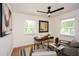 Bright home office with a wooden desk, neutral-toned furniture, and natural light from two windows at 1048 Pinehurst Se Dr, Smyrna, GA 30080
