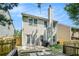 Backyard featuring a small patio and well-maintained lawn, perfect for outdoor enjoyment at 2100 Lily Valley Dr, Lawrenceville, GA 30045
