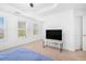 Bright bedroom with large windows, a ceiling fan, and an adjacent door at 2100 Lily Valley Dr, Lawrenceville, GA 30045