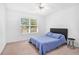 Bedroom with a ceiling fan and comfortable bed near a window, creating a serene atmosphere at 2100 Lily Valley Dr, Lawrenceville, GA 30045