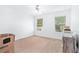 Bedroom featuring carpet flooring, two windows, and ample space, offering versatility and comfort at 2100 Lily Valley Dr, Lawrenceville, GA 30045