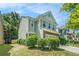 Two-story home with siding and brick, two-car garage, and manicured landscaping in a suburban setting at 2100 Lily Valley Dr, Lawrenceville, GA 30045