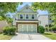 Charming two-story home featuring brick and siding exterior, attached garage, and landscaped yard at 2100 Lily Valley Dr, Lawrenceville, GA 30045
