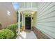 Inviting front porch with a dark door, brick accents, and well-maintained landscaping at 2100 Lily Valley Dr, Lawrenceville, GA 30045