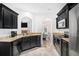 Bright, open kitchen with stainless steel appliances, black cabinets, and granite countertops at 2100 Lily Valley Dr, Lawrenceville, GA 30045