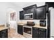 Modern kitchen featuring black cabinetry, stainless steel appliances, and granite countertops at 2100 Lily Valley Dr, Lawrenceville, GA 30045