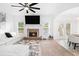 Open-concept living room featuring a fireplace, flat screen TV, and a comfortable sofa set at 2100 Lily Valley Dr, Lawrenceville, GA 30045