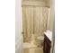 Standard bathroom with shower/tub combo behind a curtain, sink with vanity and toilet at 2545 Melville Pl, Powder Springs, GA 30127