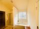 Bathroom showcasing a tub with jets, a window, and a glass-enclosed shower at 2545 Melville Pl, Powder Springs, GA 30127