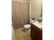 Standard bathroom with shower/tub combo behind a curtain, sink with vanity and toilet at 2545 Melville Pl, Powder Springs, GA 30127