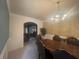 Dining room featuring a chandelier, table, and view to the living room at 2545 Melville Pl, Powder Springs, GA 30127