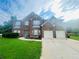 Traditional brick home with a well-manicured lawn, attached garage, and a welcoming entrance on a sunny day at 2545 Melville Pl, Powder Springs, GA 30127