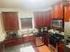 Well-equipped kitchen featuring wooden cabinets, stainless steel appliances, granite countertops, and ample counter space at 2545 Melville Pl, Powder Springs, GA 30127