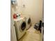 Efficient laundry room with side-by-side washer and dryer, and wire shelving at 2545 Melville Pl, Powder Springs, GA 30127
