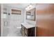 Bathroom featuring stylish vanity, a glass-enclosed shower, and a window with blinds at 357 W Hightower Trl, Social Circle, GA 30025
