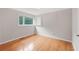 Cozy bedroom with hardwood floors, natural light, and a built-in shelving unit at 357 W Hightower Trl, Social Circle, GA 30025