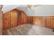 Bedroom featuring knotty pine walls and a door to the attic space at 357 W Hightower Trl, Social Circle, GA 30025