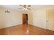 Cozy bedroom with hardwood floors, ceiling fan, and two doors leading to other spaces at 357 W Hightower Trl, Social Circle, GA 30025
