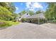 Exterior side view featuring a covered parking area and a well-kept lawn at 357 W Hightower Trl, Social Circle, GA 30025