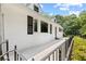 Side exterior view of a bright white house with dark trim and mature landscaping at 357 W Hightower Trl, Social Circle, GA 30025