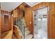 Hallway with wood paneling leading to carpeted stairs and a bathroom with a glass enclosed shower at 357 W Hightower Trl, Social Circle, GA 30025