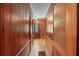 Hallway with wood paneling and trim and access to rooms behind louvered doors at 357 W Hightower Trl, Social Circle, GA 30025