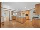 Large kitchen with wood cabinets, center island, stainless steel appliances, and hardwood flooring at 357 W Hightower Trl, Social Circle, GA 30025