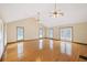 Spacious living room with cathedral ceiling features three ceiling fans, hardwood floors, and natural light at 357 W Hightower Trl, Social Circle, GA 30025