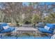 Inviting outdoor patio with comfortable seating, a stone fountain, and lush landscaping at 4340 Garmon Rd Nw, Atlanta, GA 30327